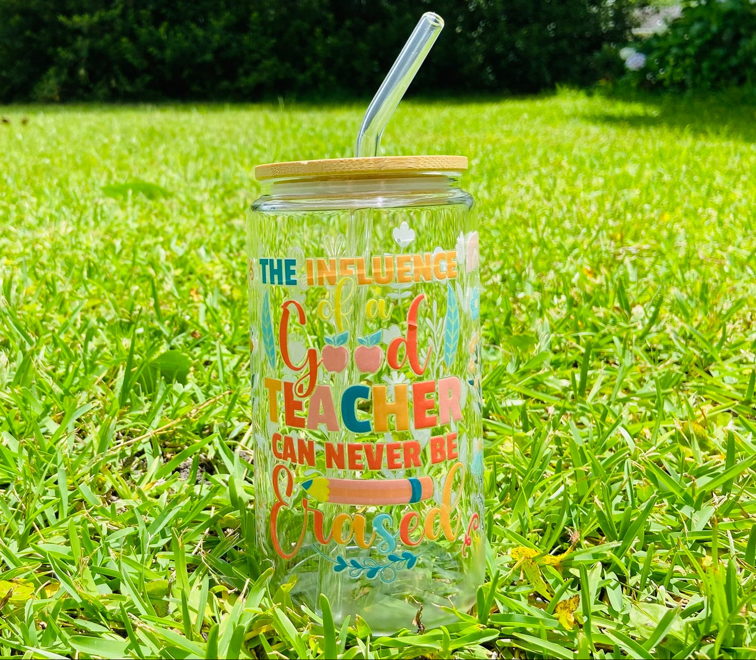 Clear tumbler with colorful text on grass