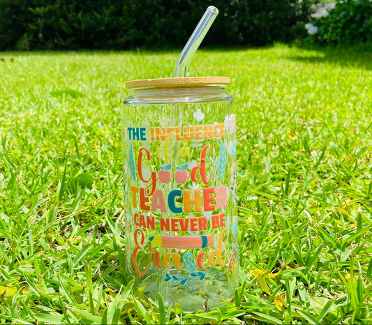 Clear tumbler with colorful text on grass